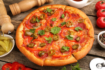 Delicious pizza Diablo, ingredients and cutter on wooden table