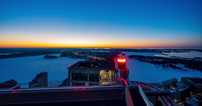 Timelapse of sunrise behind the Kalasatama skyscrapers, winter morning in Helsinki