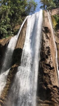 Plunging waterfall surrounded by vibrant greenery in the chanchamayo jungle, peru. Crystal-clear
