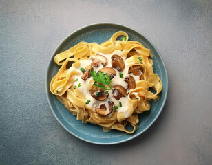 Mushroom pasta, pappardelle with cream sauce and parsley, overhead flat lay shot on a stone background