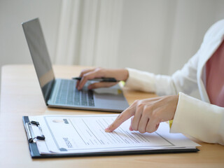 Business woman employer holds resume of job applicant To analyze data before job interviews....