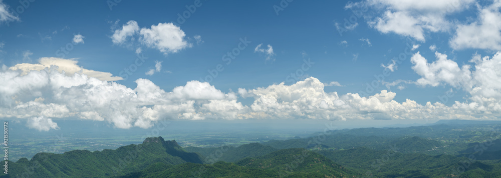 Wall mural wide panoramic view of mountain with blue sky.