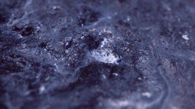 Glitter fluid texture. Shiny paint spill. Blur gray silver black color sparkling metallic dust particles ink emulsion mix liquid flow motion abstract art background.