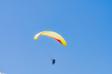 View of the sky. Person flying in a paraglider, leisure activity. Travel and landscapes.