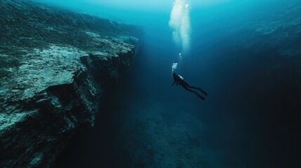 A diver explores the deep ocean, capturing the beauty and mystery of underwater landscapes in tranquil blue waters.