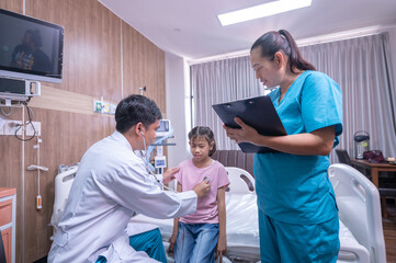 Obraz premium Photo of a doctor examining a little girl with a stethoscope in a clinic.