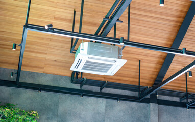 Modern ceiling mounted cassette type air conditioning system in coffee shop