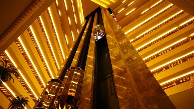 Modern luxury with this timelapse of hotel elevator. Captured from a high-end hotel, the video showcases the vertical movement of elevators as they glide up and down between floors.