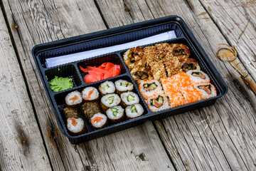 Set of the different sushi on wooden table