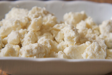 Enjoy fresh, creamy cottage cheese in a charming bowl, ideal for any meal or occasion