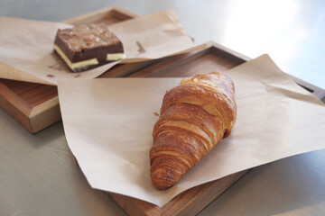 fresh baked croissant on plate with copy space 