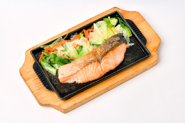 Salmon steak in a hot pan ready to eat