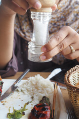 Salt falls from a salt shaker 