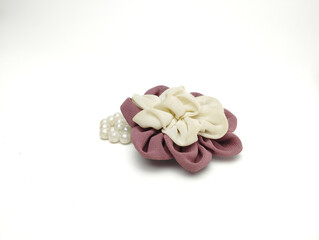 Burgundy and white brooch and handmade beads resemble bright flowers isolated on white background