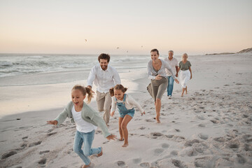 Parents, children and playful with running, beach and excited with grandparents on vacation in summer. Big family, kids and generations at sunset, care and bonding with games by ocean in Spain