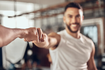 Happy man, fitness and fist bump with partner in success, workout or teamwork together at gym....