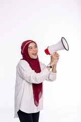 Cute and Pretty Indonesian young muslim female using a megaphone