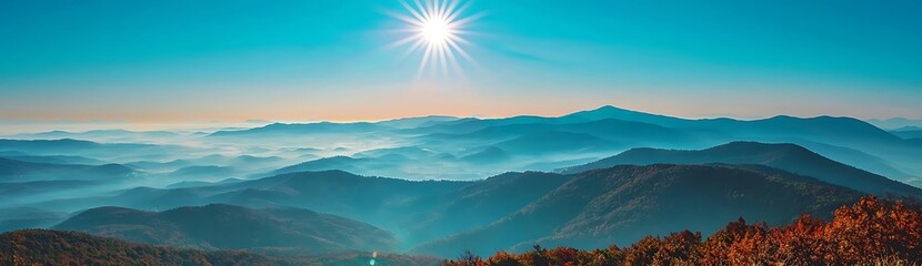 Fototapeta premium Majestic mountain range with bright sun and fog in the valley.