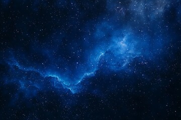 Fototapeta premium Dark blue night sky with stars and a swirling nebula in the background.