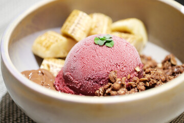 Home made Acai berry yogurt with banana, granola and dark chocolate, Healthy dessert bowl, tasty superfood