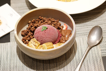 Home made Acai berry yogurt with banana, granola and dark chocolate, Healthy dessert bowl, tasty superfood