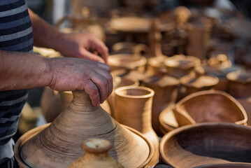 Set of national clay dishes tableware at street market in Ukraine. Various pottery items showcased for trade at clay market