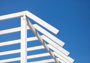 White wooden roof slats against the sky.