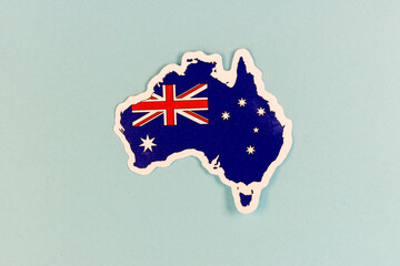 Australia Map Sticker with National Flag on Light Blue Background with Copy Space. © GreenThumbShots