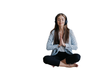 young businesswoman in a light blue blazer sits cross-legged with closed eyes, practicing meditation with headphones on, embracing mindfulness in the workplace against transparent background