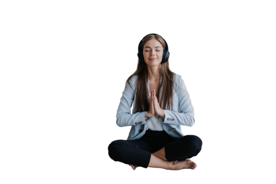 young businesswoman in a light blue blazer sits cross-legged with closed eyes, practicing meditation with headphones on, embracing mindfulness in the workplace against transparent background