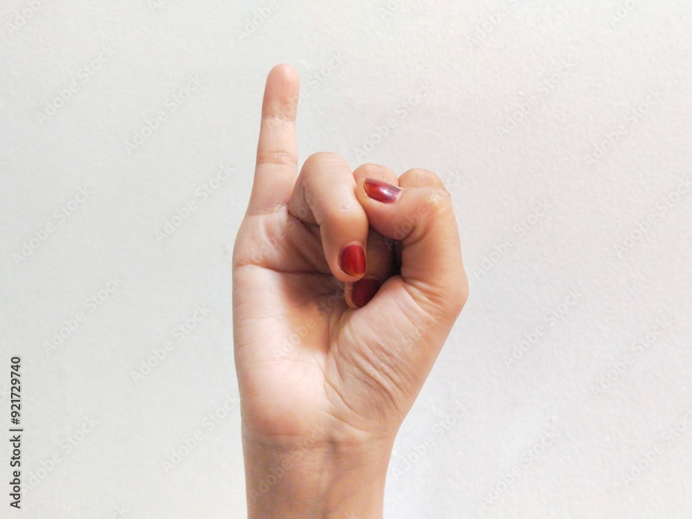 Wall mural woman's hand showing little finger or making promise gesture on white background