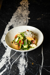 salad with rolls and greens in a plate