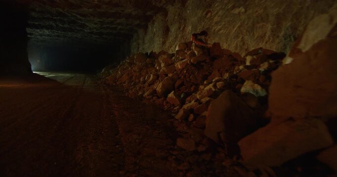 Epic running shot with adventurers in cave  - steady cam slow motion