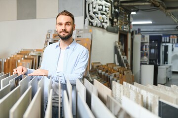 Man choosing tiles at building market