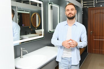 Man choosing bathroom sink and utensils for his home