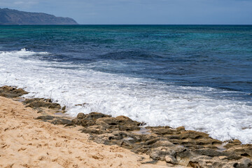 Laniakea Beach, North Shore, Oahu Hawaii. Beachrock is a friable to well-cemented sedimentary rock