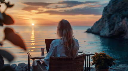 Fototapeta premium Woman Working on Laptop During Sunset on Rocky Cliff