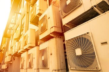 Many Air conditioner outside cooling unit office building in hot weather from global warming crisis environment impact.