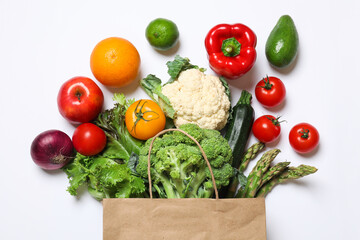 Delivery of vegetarian products. Bag with different vegetables and fruits on white background, top view