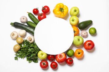 Healthy vegetarian food. Paper card surrounded by different vegetables, mushrooms and fruits on white background, flat lay