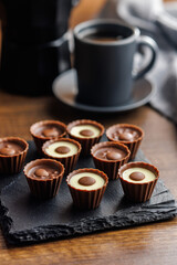 Sweet pralines. Chocolate truffles on wooden table.