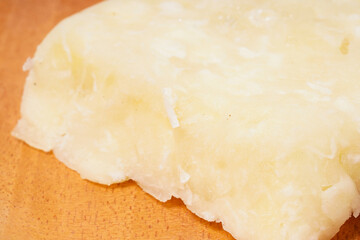 Getuk: a traditional Indonesian snack made from boiled cassava mixed with sugar and grated coconut, then mashed and shaped into flat squares. Photographed on a white background.