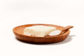 Getuk: a traditional Indonesian snack made from boiled cassava mixed with sugar and grated coconut, then mashed and shaped into flat squares. Photographed on a white background.