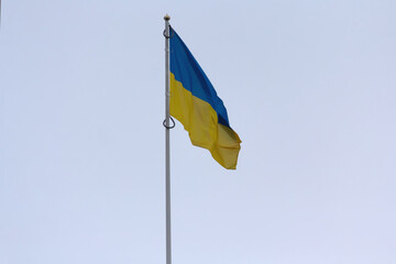 Ukrainian national flagon a flagpole against the sky
