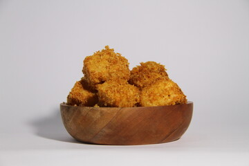 Crispy fried tofu in a wooden bowl, ready to eat.