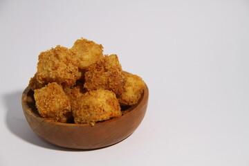 Crispy fried tofu in a wooden bowl, ready to eat.