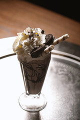 Chocolate milkshake with whipped cream and chocolate wafer sticks