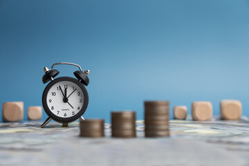 Tax time on alarm clock and coins