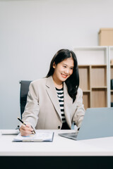 Business woman using tablet and laptop for doing math finance on an office desk, tax