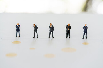 Group of miniature people businessman stands on graph to analyze data. Business and financial. Agenda plan on schedule event, work planning. Commitment, agreement, investment and partnership concept